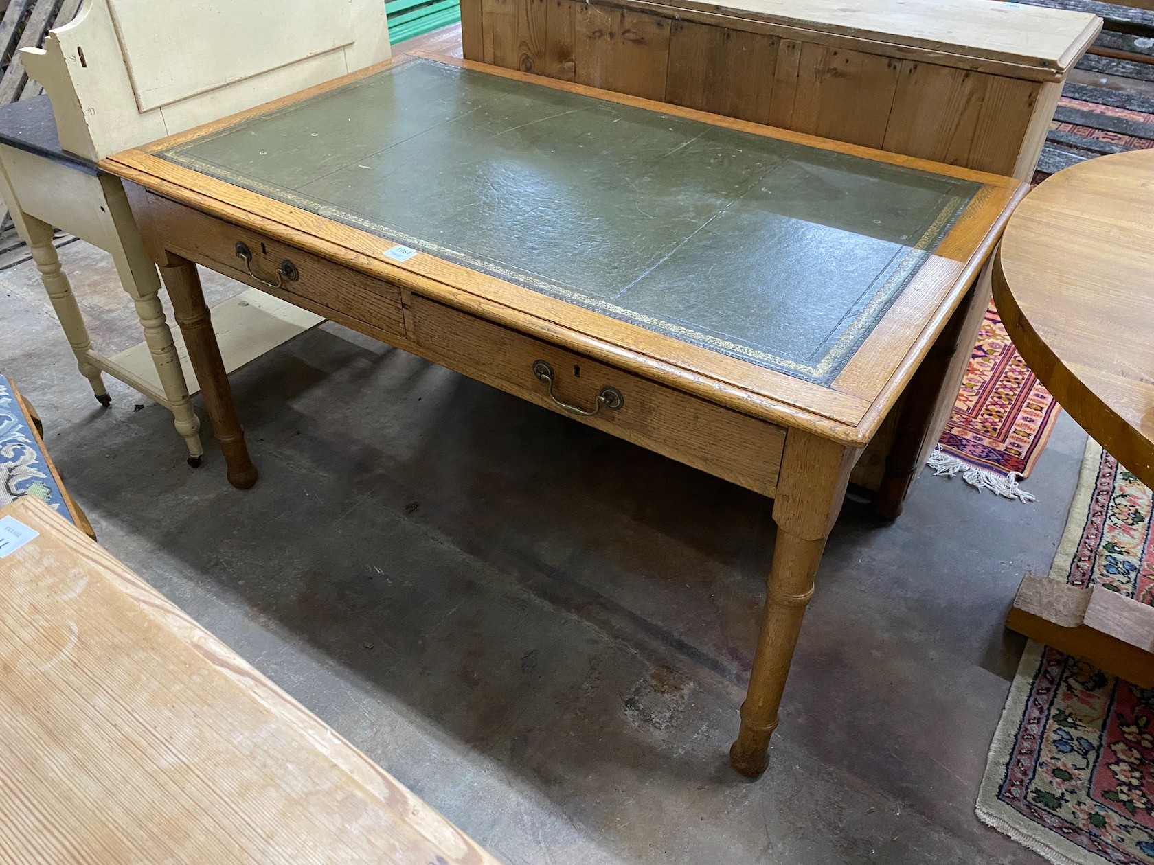 An early 20th century oak writing table, width 137cm